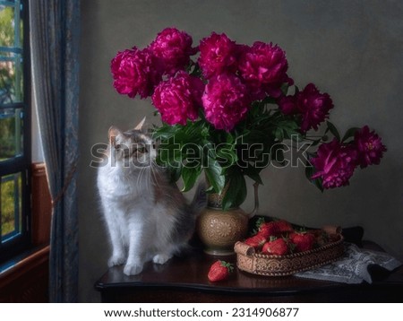 Still life with bouquet of peonies, strawberries and pretty kitty