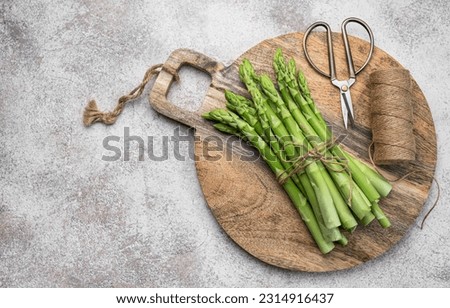 Fresh green asparagus  on grey concrete background. Flat lay