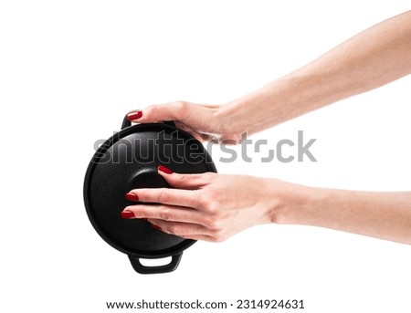 Black pot in hands isolated on white background. High quality photo