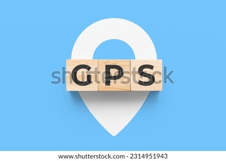 GPS (Global Positioning System) wooden cubes on blue background  Royalty-Free Stock Photo #2314951943