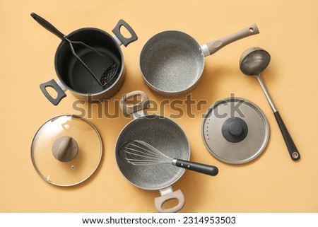 Set of kitchen utensils on beige background Royalty-Free Stock Photo #2314953503