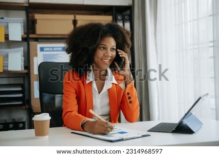 African businesswoman working in the modern office with working notepad, tablet and laptop documents 
