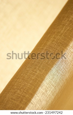 Beige textile with a pattern of light and shade