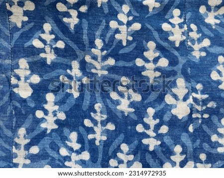 White floral motif on indigo block printed fabric dabu print