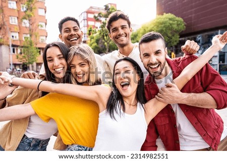 Multiracial best friends having fun outside - Group of young people smiling at camera outdoors - Friendship concept with guys and girls hanging out on city street 
