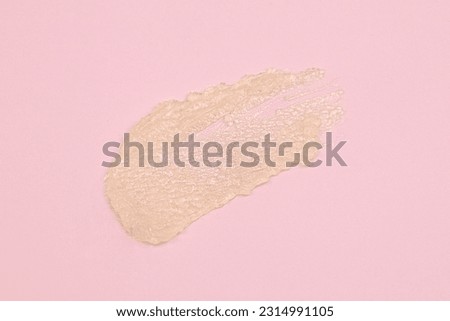 Smear of cream or vegan lip balm on pink background. Top view. Close up. Royalty-Free Stock Photo #2314991105