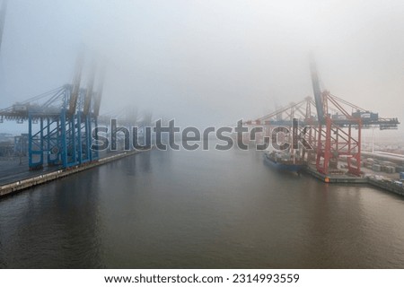the waltershofer harbor in hamburg on a foggy day Royalty-Free Stock Photo #2314993559