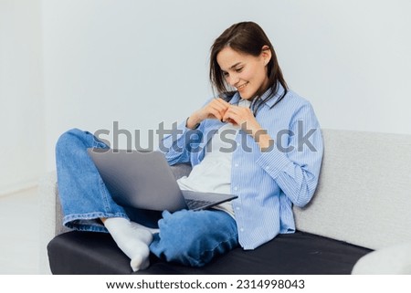 woman in bright room behind a laptop in a room remote work internet online