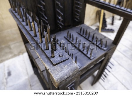 Spikes and nails chair, instrument of torture, inquisition Royalty-Free Stock Photo #2315010209