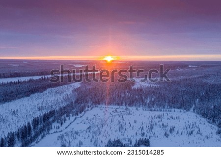 The northern sun is low on the horizon. Landscape of winter taiga. Russian winter of northern latitudes from a drone. Royalty-Free Stock Photo #2315014285