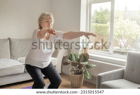 Gym at home. Active senior woman exercising at home. Healthy lifestyle