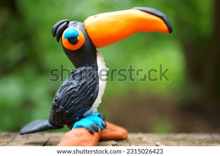 Toy bird toucan close-up. Exotic rare animals.
