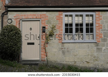 Exterior view of a beautiful old traditional cottage house on a street in an English town Royalty-Free Stock Photo #2315030415