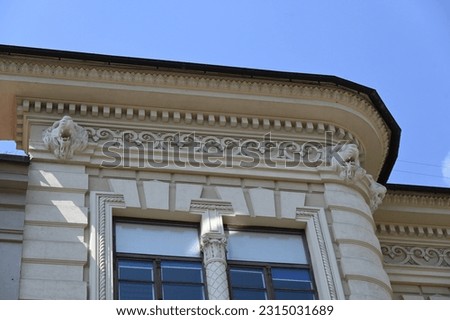 the wide decorated cornice of the historic building