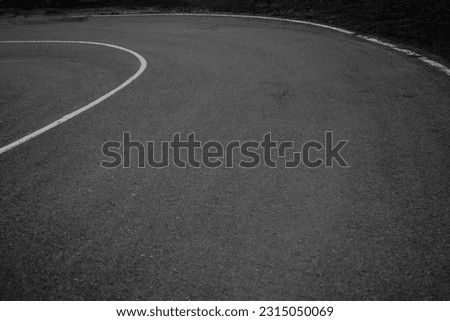 new Asphalt road turn. A view of an asphalt road with sunset scenery in the background. curve Empty asphalt road in rural landscape at sunset. 