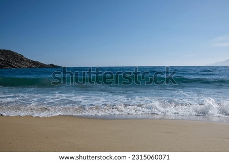 Waves and sea foam at the beautiful beach of Mylopotas in Ios Greece
