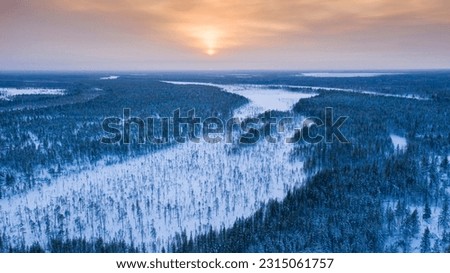 The northern sun is low on the horizon. Landscape of winter taiga. Russian winter of northern latitudes from a drone. Royalty-Free Stock Photo #2315061757