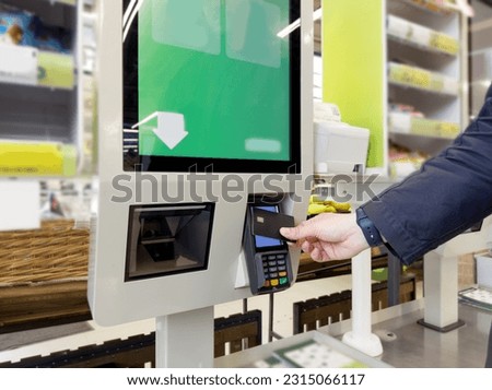 Customer pays his purchase at the supermarket,self checkout systems in  retail stores,Barcode scanner,Self checkout machine Royalty-Free Stock Photo #2315066117