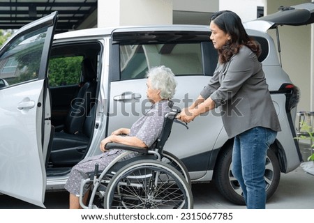 Caregiver help and support asian elderly woman sitting on wheelchair prepare get to her car to travel in holiday.