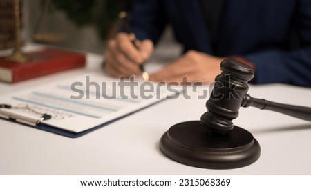 Male lawyer working with law book, A legal binding, Unilateral contract, Multilateral, Non-reciprocal contract, Default, Obligation, Power of attorney, Defense of a prescription, Court decree Royalty-Free Stock Photo #2315068369