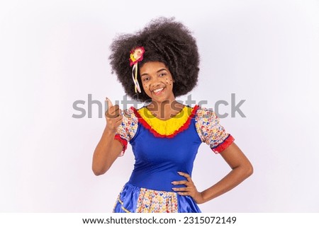 portrait, Black Brazilian woman in festa junina clothes. Saint John's festival. thumb up.
