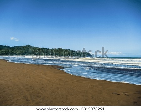 the atmosphere of the beach in Cilacap during the day looks very hot and bright with a blue sky