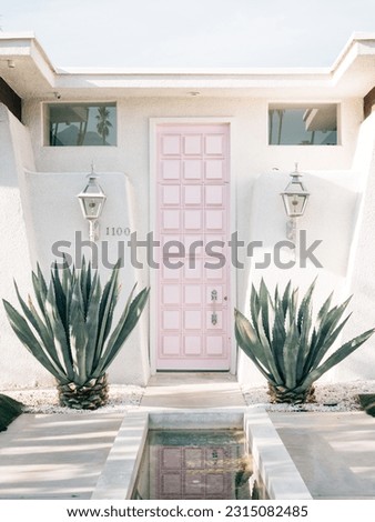 White house with a pink door, in Palm Springs, California Royalty-Free Stock Photo #2315082485