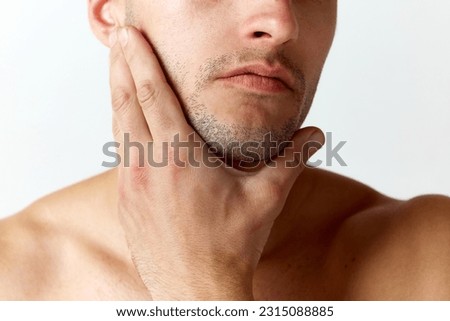 Cropped close-up image of male face with bristle against white studio background. Shaving. Concept of men's beauty, skincare, cosmetology, spa, health. Copy space for ad Royalty-Free Stock Photo #2315088885