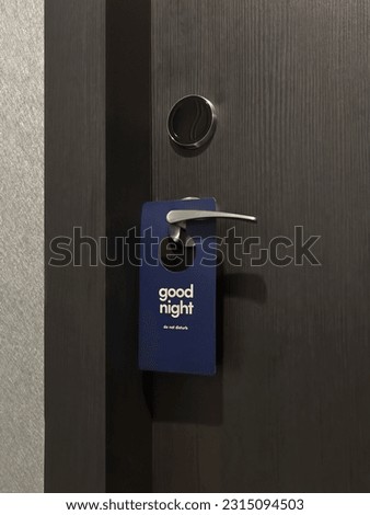 Hotel door room with do not disturb sign.
