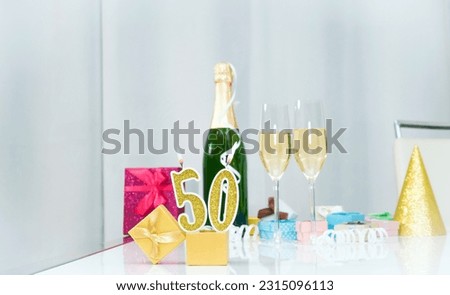 Date of birth with number  50. Festive Champagne in glasses with gift boxes, anniversary postcard. Happy birthday golden candles.
