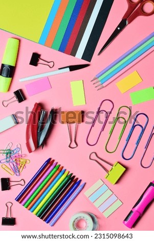 School supplies, various accessories in full color copy space. Zenith view and vertical shot, pink background.