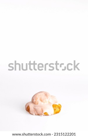 fresh bun with delicate cream on a white background