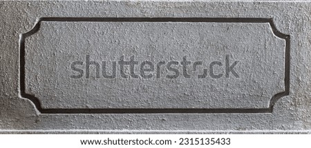 Grooves created on the concrete. Rectangle created in cement wall.
Stencil in concrete wall. Round corners in cement wall.