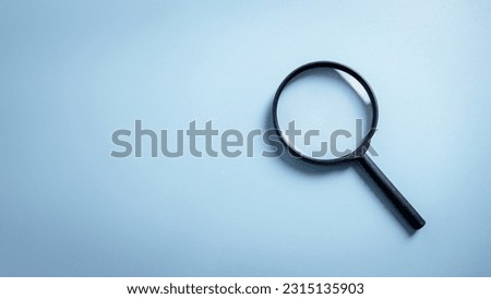 Top view empty lens black magnifying glass on white blue pastel background. Flat lay object and inspection investigation equipment tool symbol concept. Police and Forensic Science theme. Copy space.