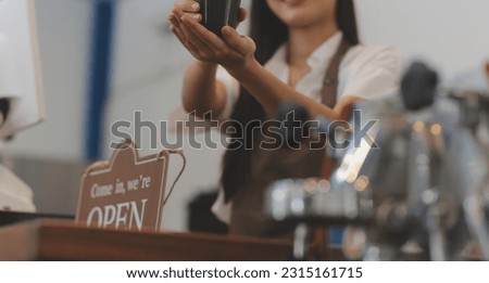Open. barista, waitress woman wearing protection face mask turning open sign board on glass door in modern cafe coffee shop, cafe restaurant, retail store, small business owner, food and drink concept