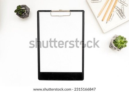 Copy space blank clip board and office supplies, top view. Royalty-Free Stock Photo #2315166847