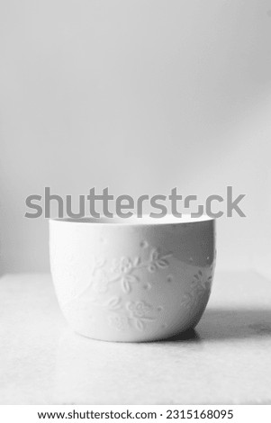 Large white mug with floral pattern on a marble tray, white coffee cup