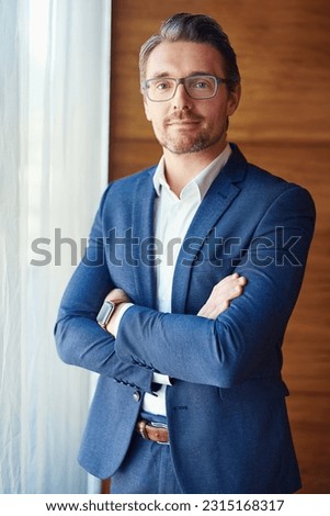 Business, portrait of businessman with arms crossed and standing in his office, Confident or proud, ceo management or mature manager and professional corporate man stand in modern workplace Royalty-Free Stock Photo #2315168317
