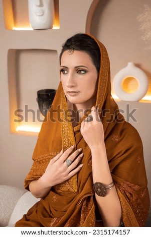 young beautiful indian woman in a photo studio, close-up, selective focus
