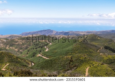 Panoramic mountain road through Vallehermoso near Fortaleza de Chipude on western coast of La Gomera, Canary Islands, Spain, Europe. Lush green valley and hills. Start descending to Valle Gran Rey