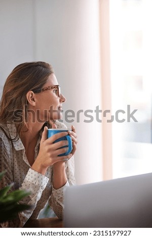 Coffee, thinking and woman in home office with laptop, daydreaming and enjoy peaceful remote work break. Freelance, relax and female person with tea while working online on proposal plan or project Royalty-Free Stock Photo #2315197927