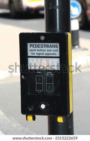 button to request passage in a pedestrian crossing