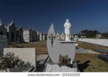 European cemetery with granite graves, crucifix, christ and chapels