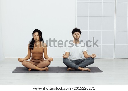 a rest flexible body poses yoga woman and man do gymnastics warm-up