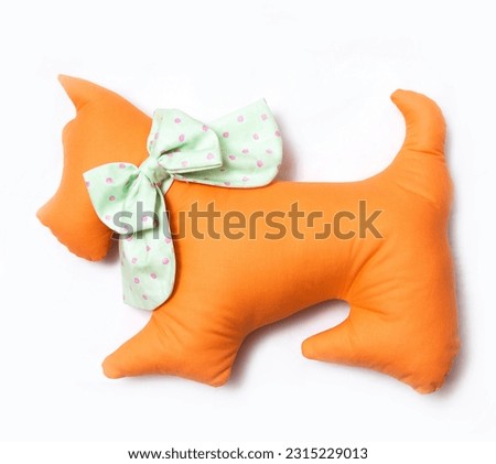 Handmade toy orange cat pillow with ornament isolated at white background