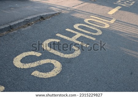 Yellow road marking "School" UK