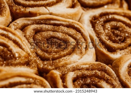 Tasty cinamon sour dough rolls with sugar. Close up of sweet homemade pastry.  Royalty-Free Stock Photo #2315248943
