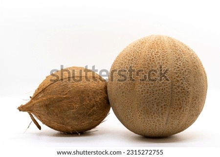 Close up Tropical fruits melon and coconut uncut unbroken unopened isolated on white background. Selective focus.