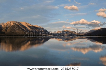 Peaceful mountain lake with reflections in sunset. Kananaskis lake near Canmore. Canadian Rockies.  Alberta. Canada