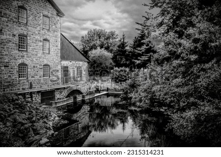 The Old Stone Mill National Historic Site in Delta, Leeds County, Ontario is one of the oldest surviving mills in the province. Black and white.